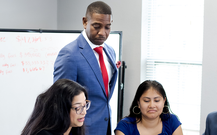 Attorney Ezekiel Tyson Jr. consulting with clients at The Tyson Law Firm.